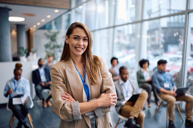 Portrait of confident public speaker during business conference looking at camera