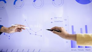 Personas revisando gráficas de economía circular y sostenibilidad en marketing